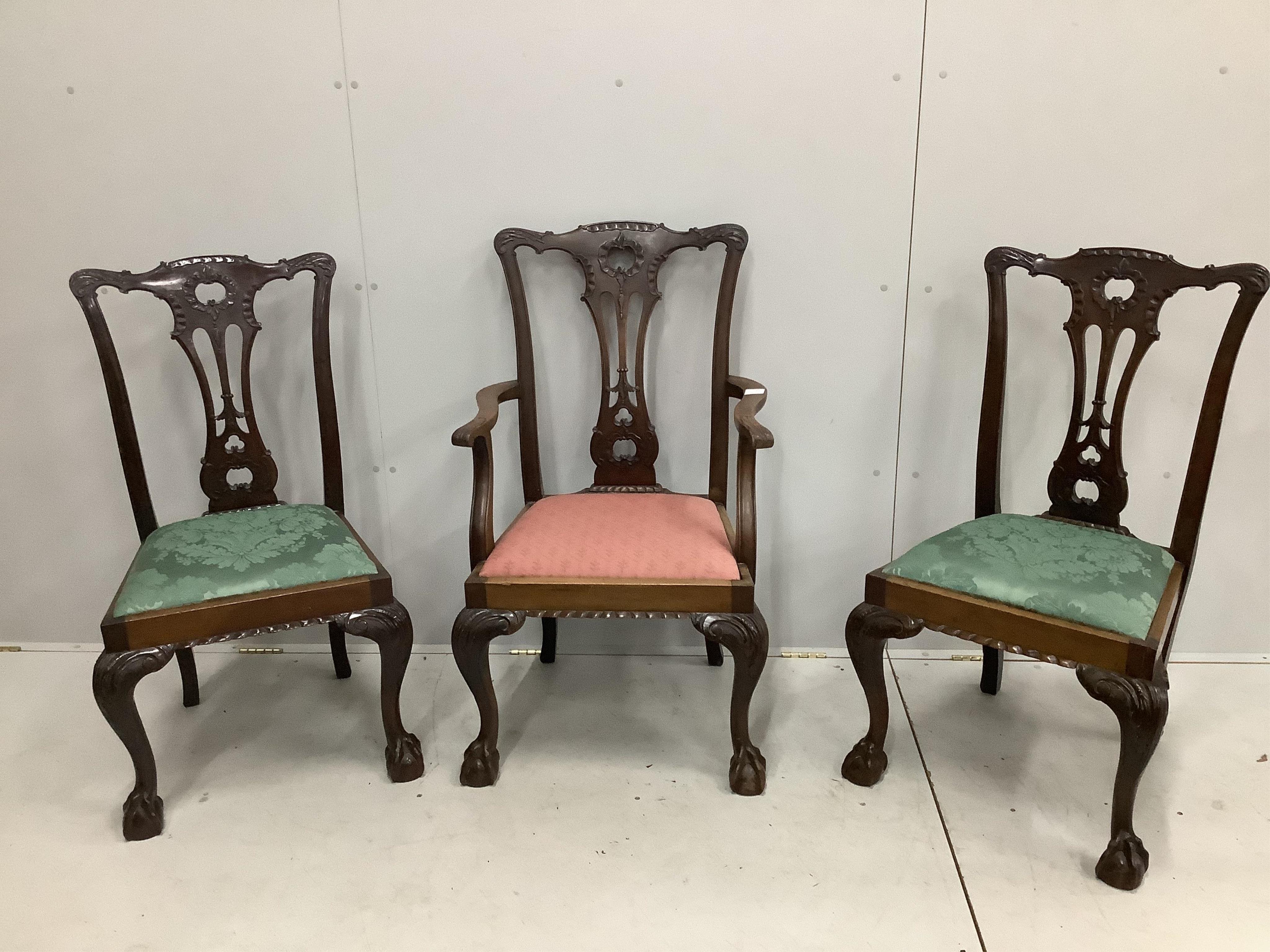 A set of three Chippendale style mahogany dining chairs, one with arms. Condition - fair